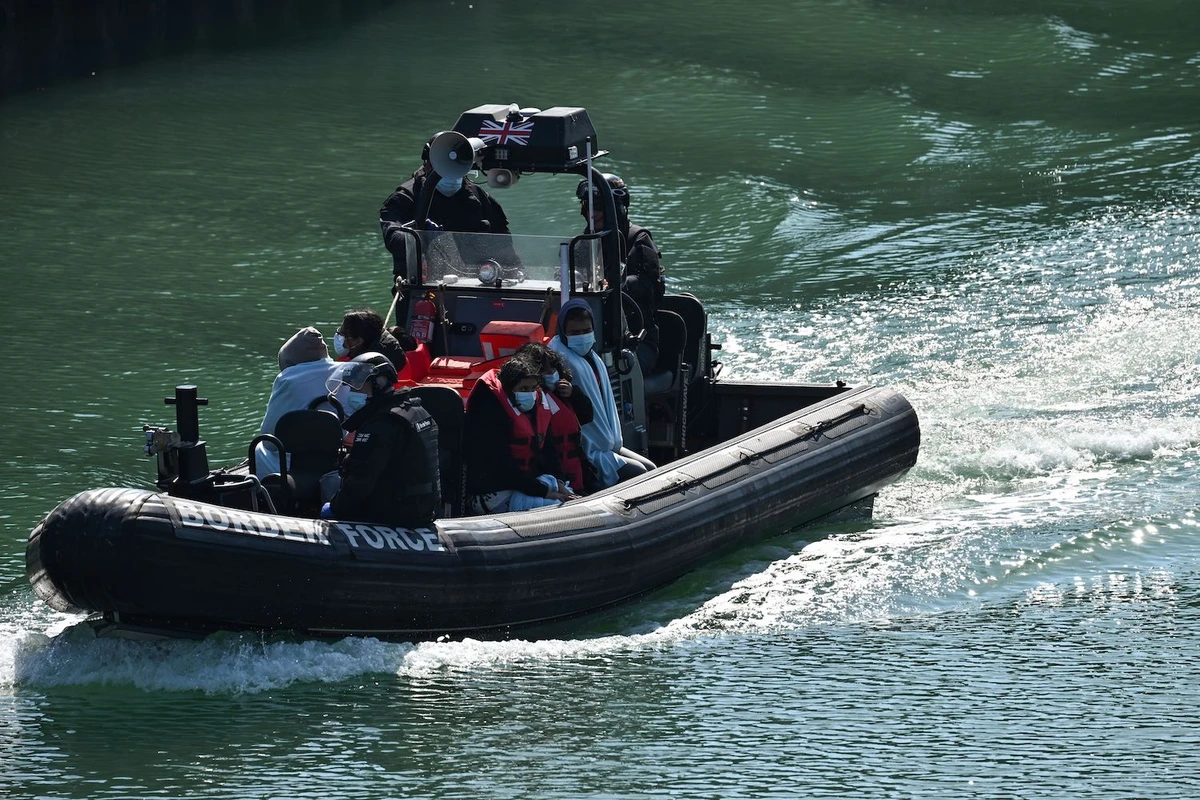 Migrants are seen on the UK Border Force rubber dinghy, after they were picked up at sea while attempting to cross the English Channel. (File/AFP)