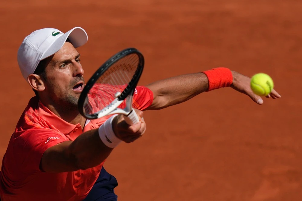 Serbia's Novak Djokovic plays a shot against Russia's Karen Khachanov during their quarter final match of the French Open tennis tournament at the Roland Garros stadium in Paris Tuesday. (AP)