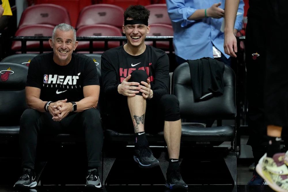 Miami Heat guard Tyler Herro, right, laughs as he watches from the bench during a practice ahead of Game 3 of the NBA Finals, at the Kaseya Center in Miami, Tuesday. (AP)