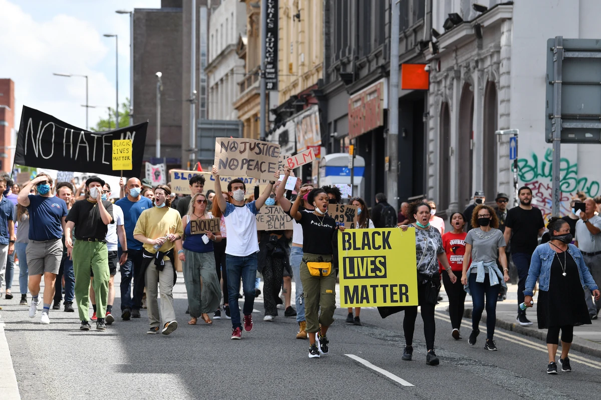 Protesters with banners and placards march from Toxteth into central Liverpool in support of the Black Lives Matter movement at a protest in Liverpool. (File/AFP)