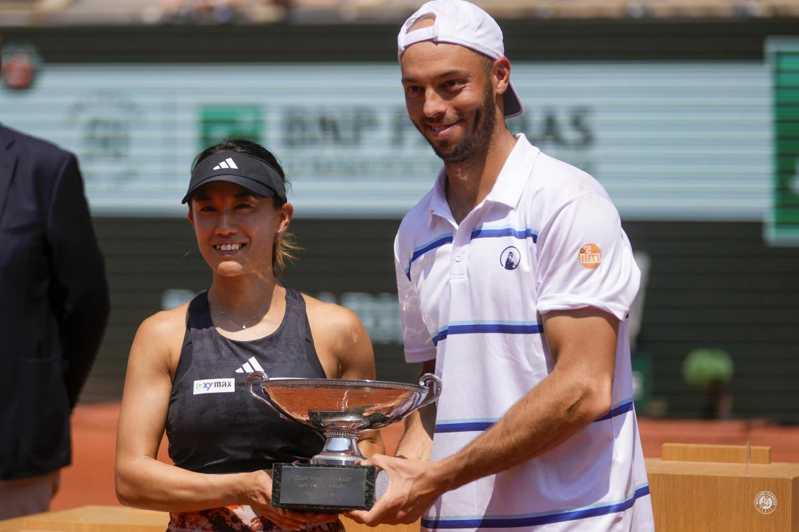 Japan’s Miyu Kato and Germany’s Tim Puetz hold the trophy after winning the mixed doubles final match of the French Open tennis tournament at the Roland Garros stadium in Paris on Jun. 8, 2023. (AP)
