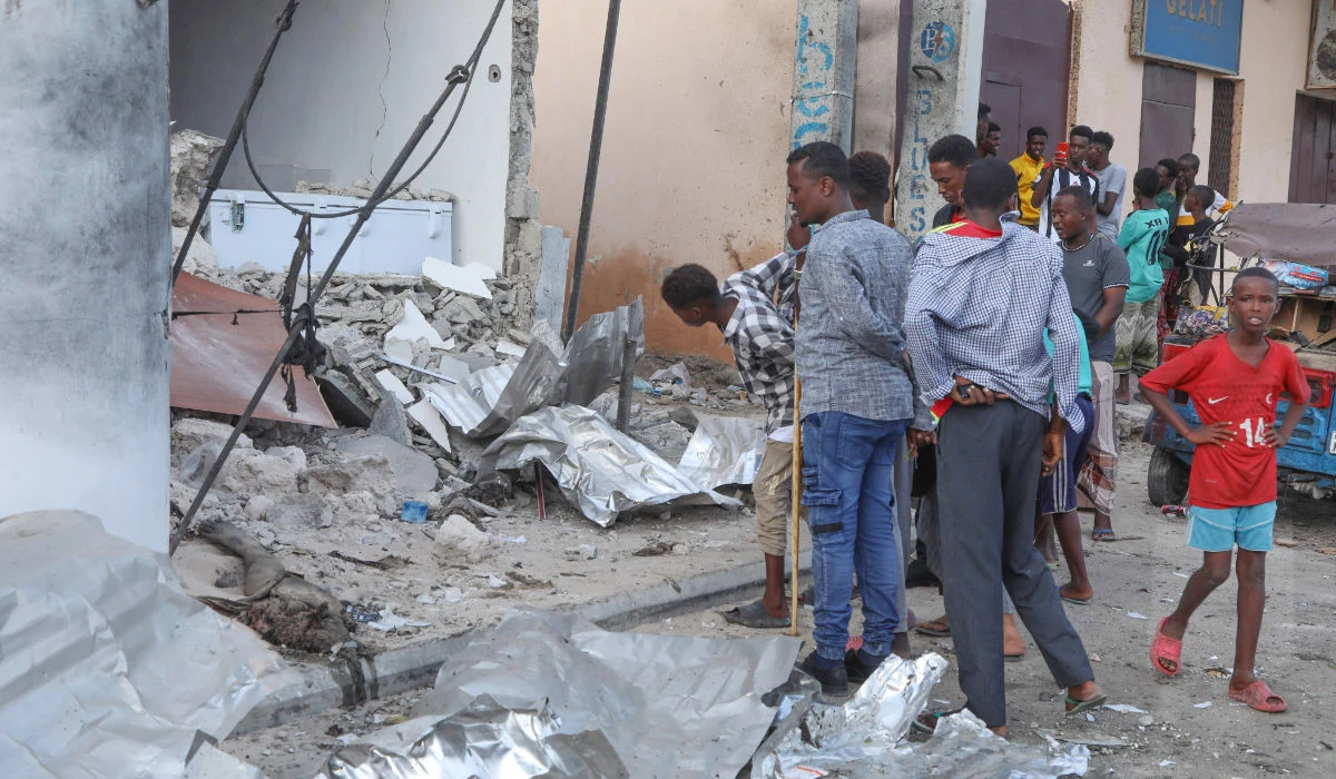Residents assess the damages at the site of an attack on Saturday at the Pearl Beach Hotel. Security forces have brought to an end the siege of the hotel. (AFP)