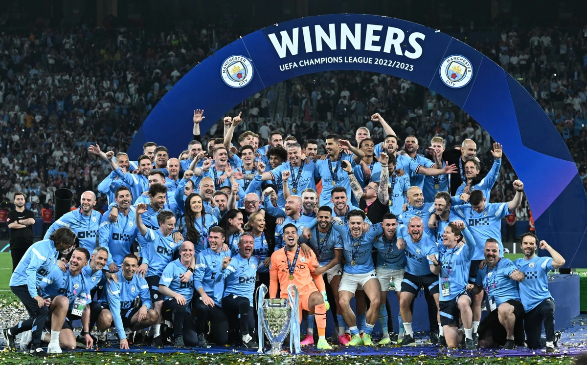 Manchester City's Brazilian goalkeeper #31 Ederson and teammates pose with the European Cup trophy as they celebrate winning the UEFA Champions League final football match between Inter Milan and Manchester City at the Ataturk Olympic Stadium in Istanbul (AFP)