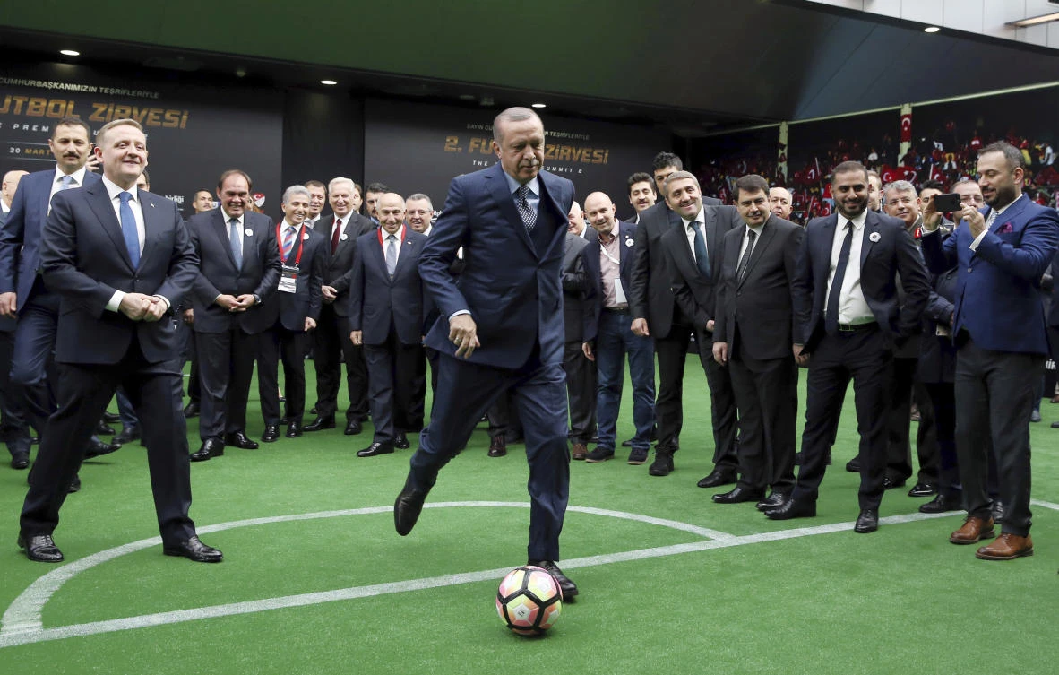 Erdoğan sat next to UEFA leader Aleksander Čeferin and mixed with the voters who will choose the hosts in October. (AP)