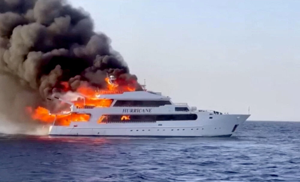 Plumes of smoke erupt from a yacht on fire in Marsa Alam, Egypt, June 11, 2023 in this screengrab taken from a handout video. (Reuters)