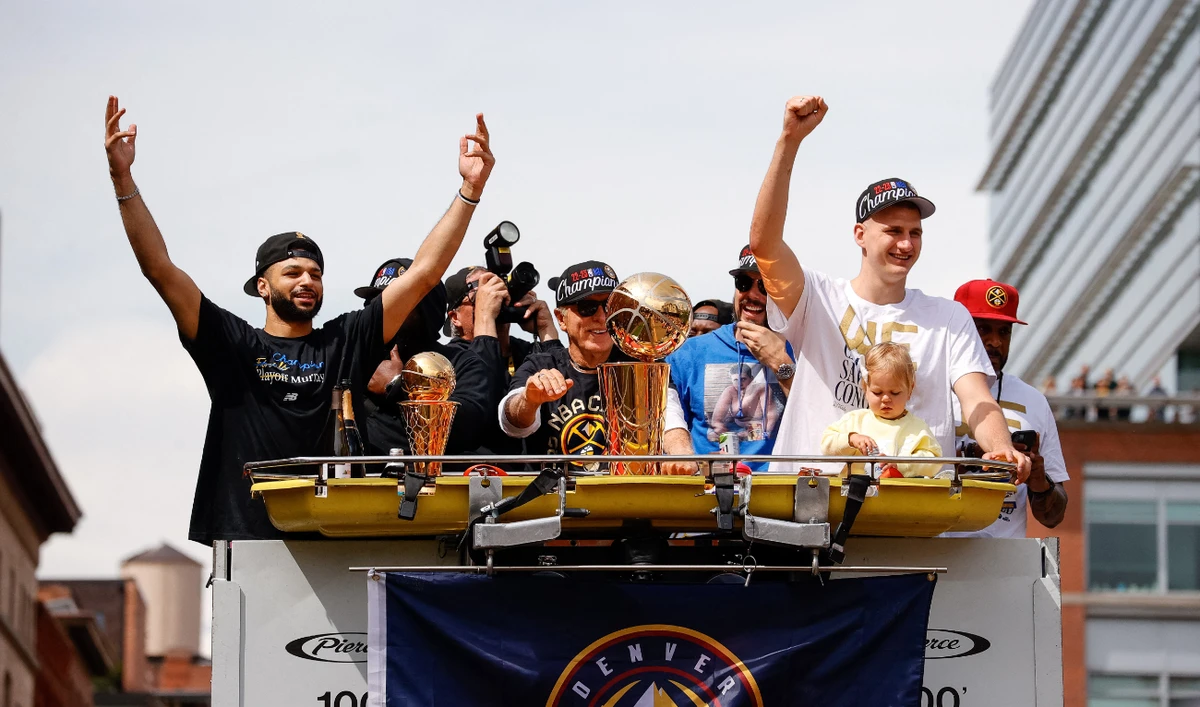 Denver Nuggets guard Jamal Murray (L), owner Stan Kroenke (C) and center Nikola Jokic (R) during the championship parade after the Denver Nuggets won the 2023 NBA Finals. (USA TODAY Sports)