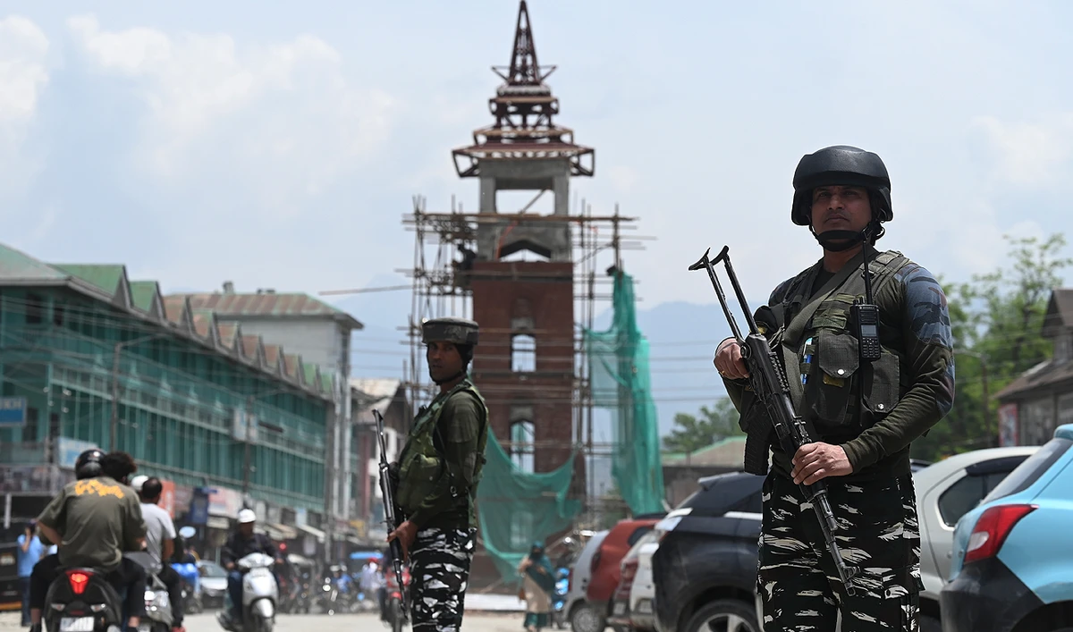Indian paramilitary troopers stand guard along a road in Srinagar on May 16, 2023. (AFP)