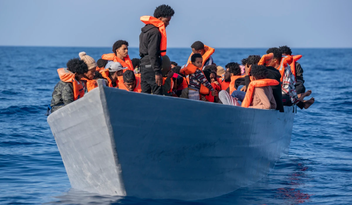 Migrants from Eritrea, Libya and Sudan crowd the deck of a wooden boat in the Mediterranean Sea as they wait to be assisted by aid workers. (AP)