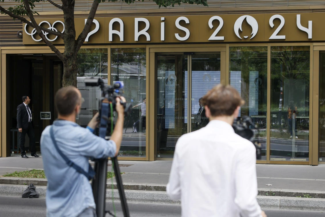 Reporters work outside the headquarters of the Paris Olympic organizers, on June 20, 2023 in Saint-Denis, outside Paris. (AP)