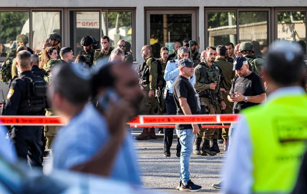 Israeli soldiers and police gather outside a restaurant at the scene of an attack near the Jewish settlement of Eli in the north of the occupied West Bank on June 20, 2023. (AFP)