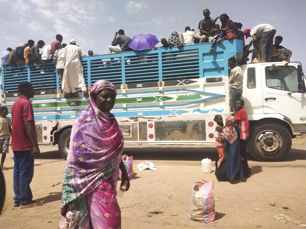 Residents board a truck to take advantage of the ceasefire and flee brutal fighting in Khartoum, Sudan on June 19, 2023. (AP)