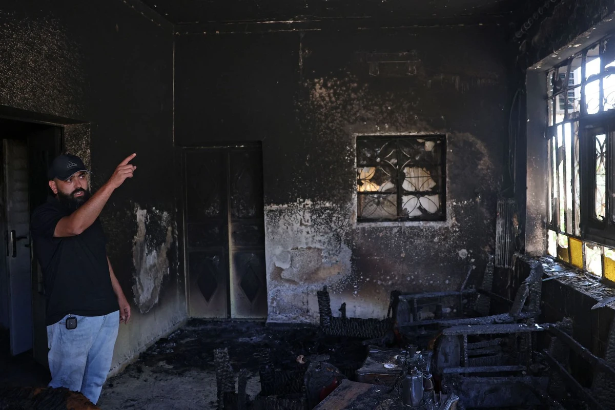 A Palestinian gestures inside his home, which was set on fire by Israeli settlers the day before, in Turmus Aya near Ramallah, on June 22, 2023. (AFP)