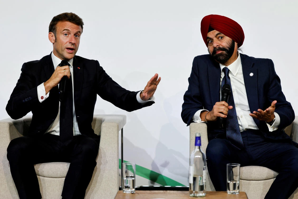 French President Emmanuel Macron gestures as he takes part in a round table discussion next to World Bank President Ajay Banga during the New Global Financial Pact Summit at the Palais Brongniart in Paris. (Reuters)