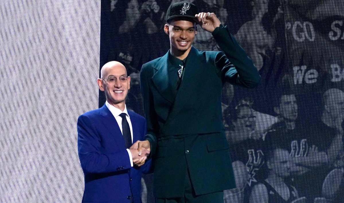 French basketball player Victor Wembanyama (R) shakes hands with NBA commissioner Adam Silver after being picked by the San Antonio Spurs during the NBA Draft at Barclays Center in New York city on Thursday. (AFP)