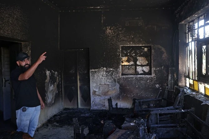 A Palestinian gestures inside his home, which was set on fire by Israeli settlers the day before, in Turmus Aya near Ramallah, on June 22, 2023. (AFP)