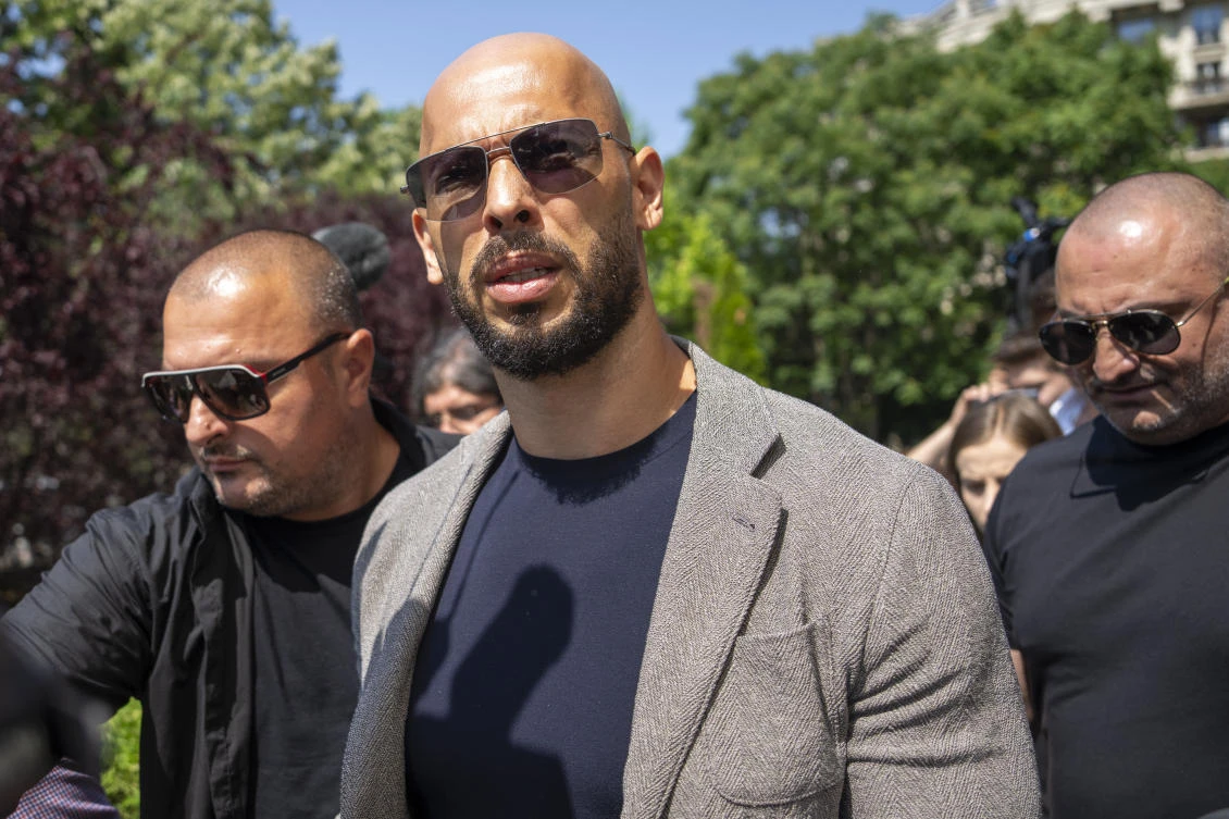Andrew Tate walks between bodyguards as he arrives at the Bucharest Tribunal, in Bucharest, Romania, on June 21, 2023. (AP)