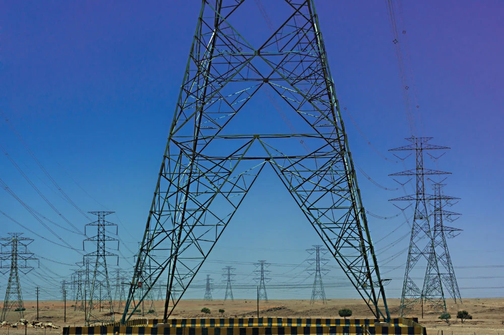 The power grid interconnection project with Iraq entails the implementation of a dual-circuit transmission line connecting the northern city of Afar in Saudi Arabia to Yusufiya in western Baghdad. (Reuters/File)