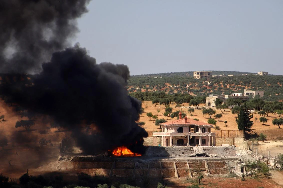 A plume of smoke rises from a building following a reported Russian air strike on Syria's northwestern rebel-held Idlib province, on June 25, 2023. The strikes killed at least seven people, including four civilians, in retaliation for deadly drone attacks blamed on rebel forces, a war monitor said. (AFP)