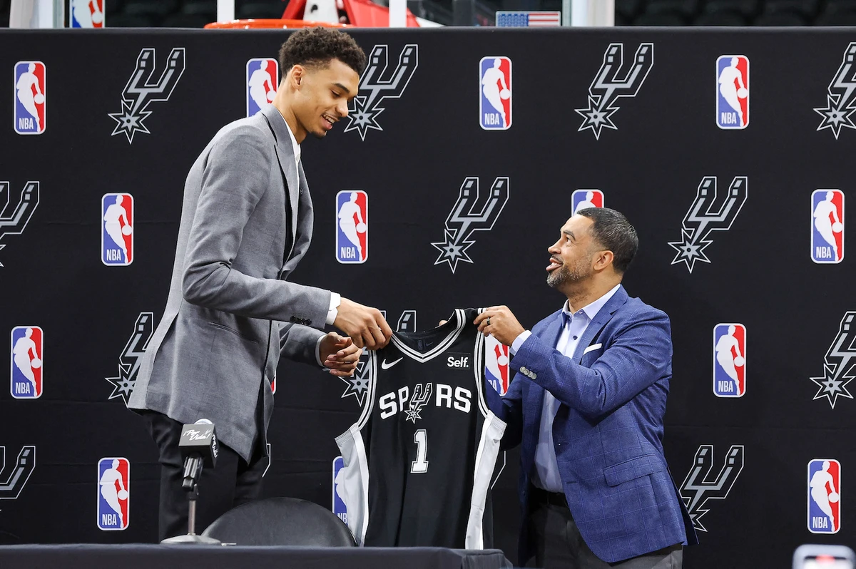 San Antonio Spurs draft pick Victor Wembanyama (left) is presented with a jersey by general manager Brian Wright during a press conference at AT&T Center. (AP)
