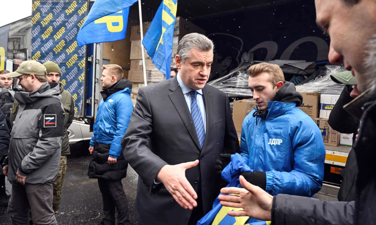 Russia's Liberal-Democratic Party of Russia (LDPR) leader Leonid Slutsky (C) greets volunteers before they start the party's humanitarian aid convoy to Eastern Ukraine in front of the State Duma building in Moscow on March 2, 2023. (AFP)