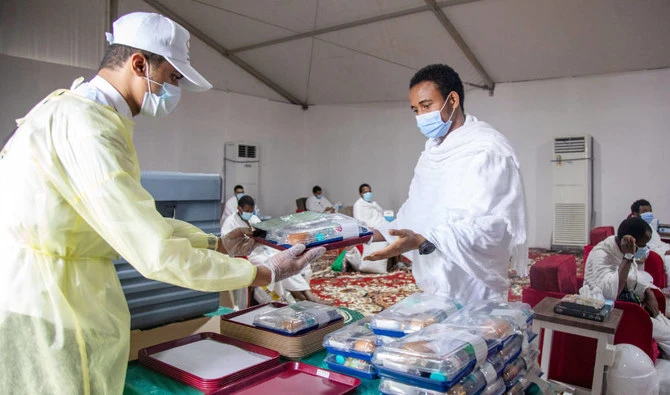 A pilgrim receives food on the plains of Arafat during the annual Hajj pilgrimage outside the holy city of Makkah, Saudi Arabia. (REUTERS)