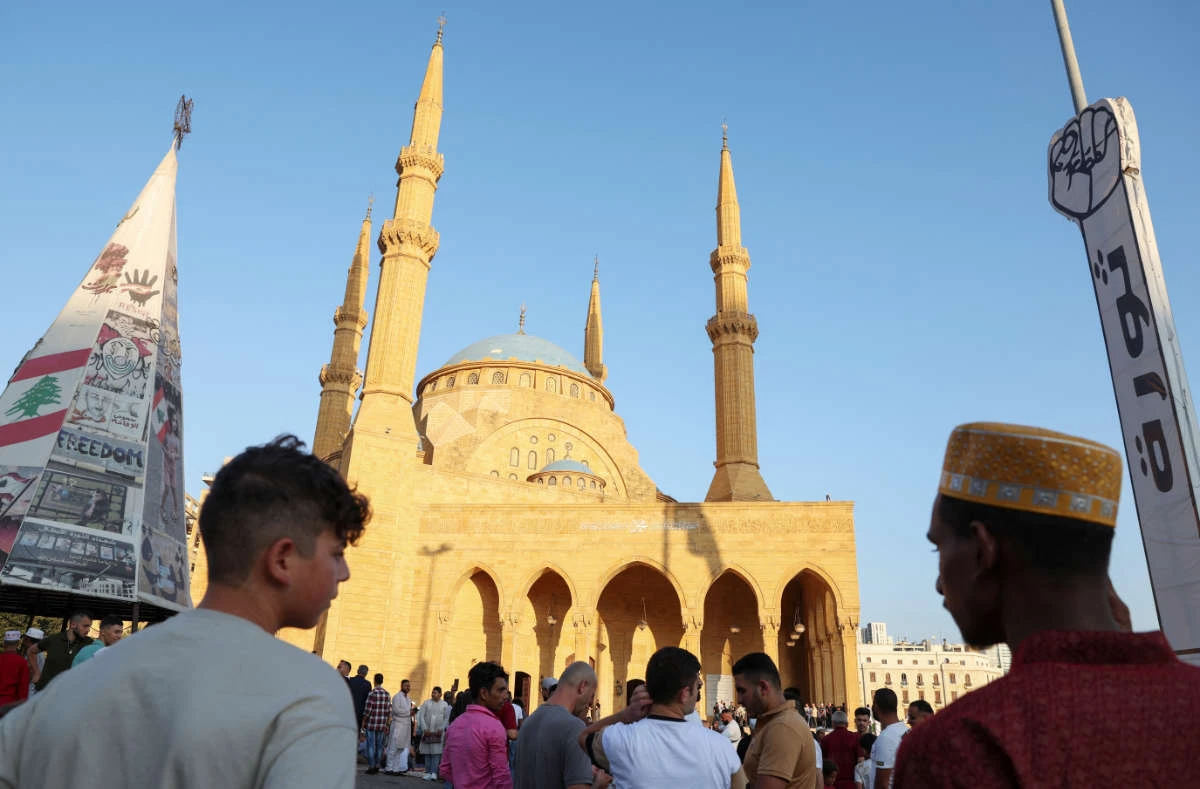 Muslims stand in front of Al-Amin mosque in downtown Beirut after their prayer on the first day of Eid al-Adha in Beirut, Lebanon June 28, 2023. (REUTERS)