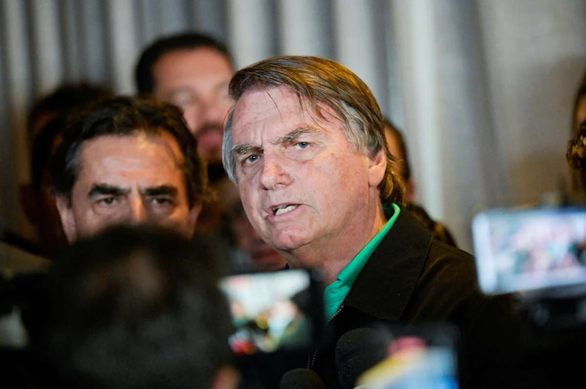 Brazil's former President Jair Bolsonaro talks with media at a restaurant, on the day the Electoral Justice continues the trial to determine his political rights, in Belo Horizonte, Brazil June 30, 2023. (REUTERS)