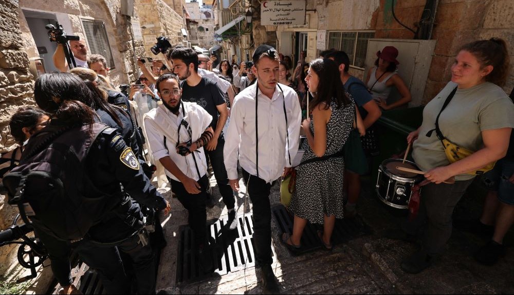 Young Israelis walk in Old Jerusalem following an eviction in the Muslim Quarter to make way for settlers, July 11, 2023. (AFP)