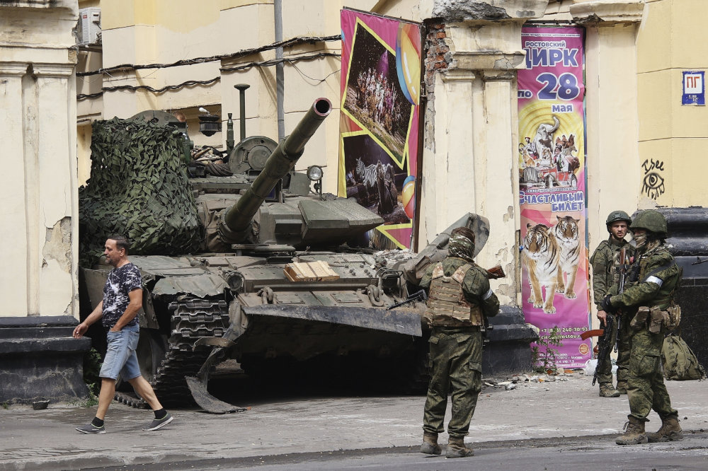 Members of the Wagner Group military company guard an area standing in front of a tank in Rostov-on-Don, Russia. (AP)