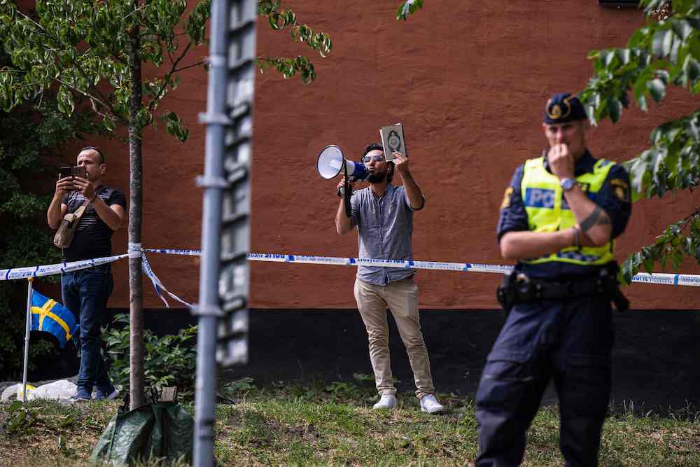 Salwan Momika, who fled from Iraq to Sweden several years ago, earlier this week stomped on the Qur’an before setting several pages alight in front of the mosque in Stockholm. (AFP)