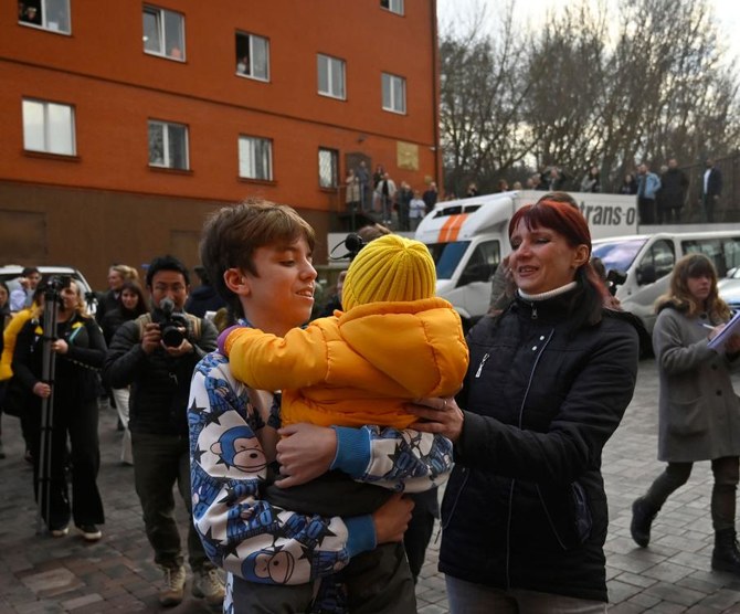 Inessa meets her son Vitaly after the bus delivering him and more than a dozen other children back from Russian-held territory arrived in Kyiv on March 22, 2023. (AFP/File)