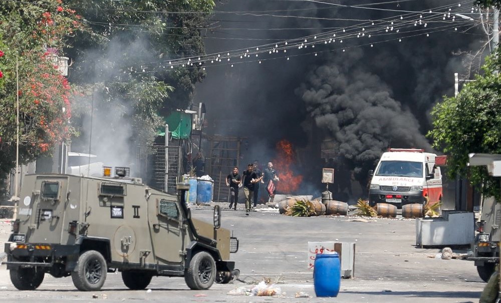 Palestinians run during clashes with Israeli forces amid an Israeli military operation in Jenin, in the Israeli-occupied West Bank, July 3, 2023. (Reuters)