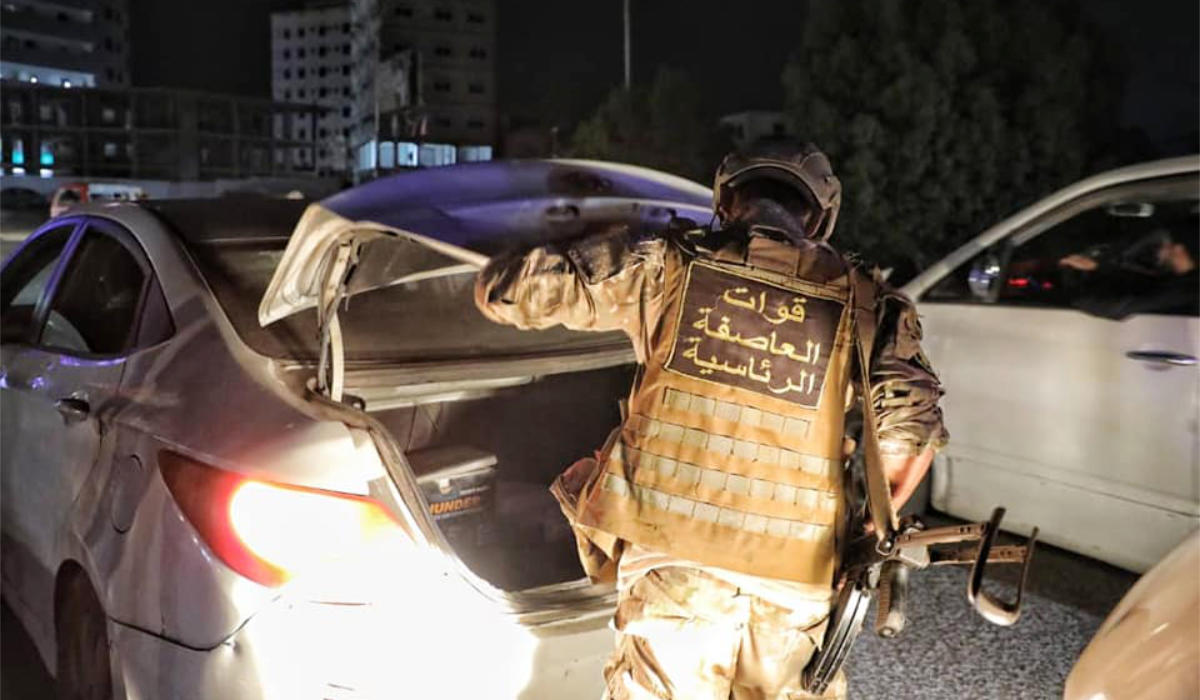 A security officer checks a car for weapons. (Supplied)