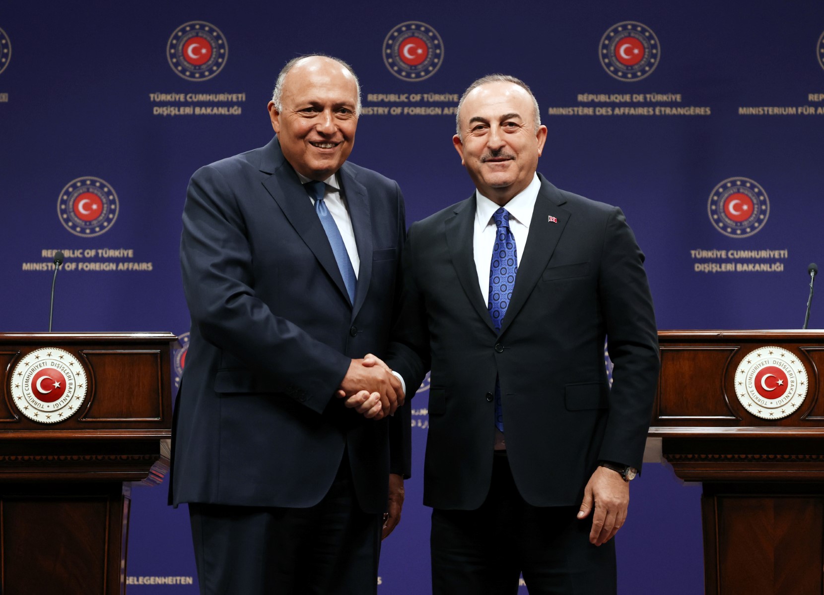 Turkish Foreign Affairs Minister Mevlut Cavusoglu, right, and Egyptian Foreign Affairs Minister Sameh Shoukry shake hands as they hold a joint news conference in Ankara on April 13, 2023. (AFP)