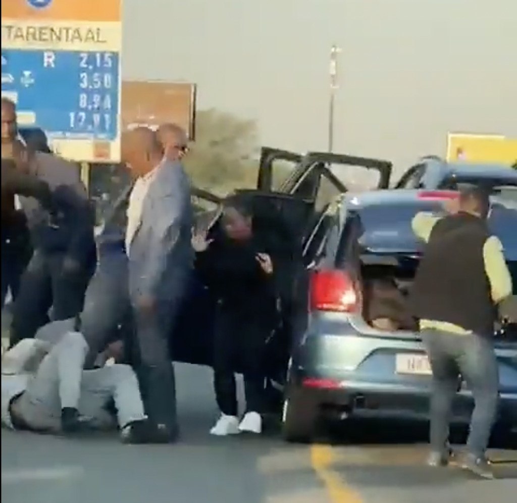 The video shows officers, some of whom are holding rifles, kicking a man and stomping on his head and body. (Screen grab/Twitter)