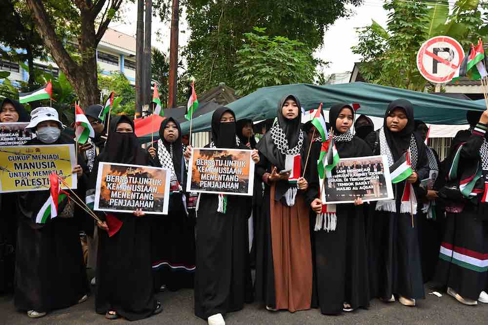 Muslim women participate in a rally to support Palestine and condemn Israel, outside the Palestine embassy in Jakarta. (AFP)