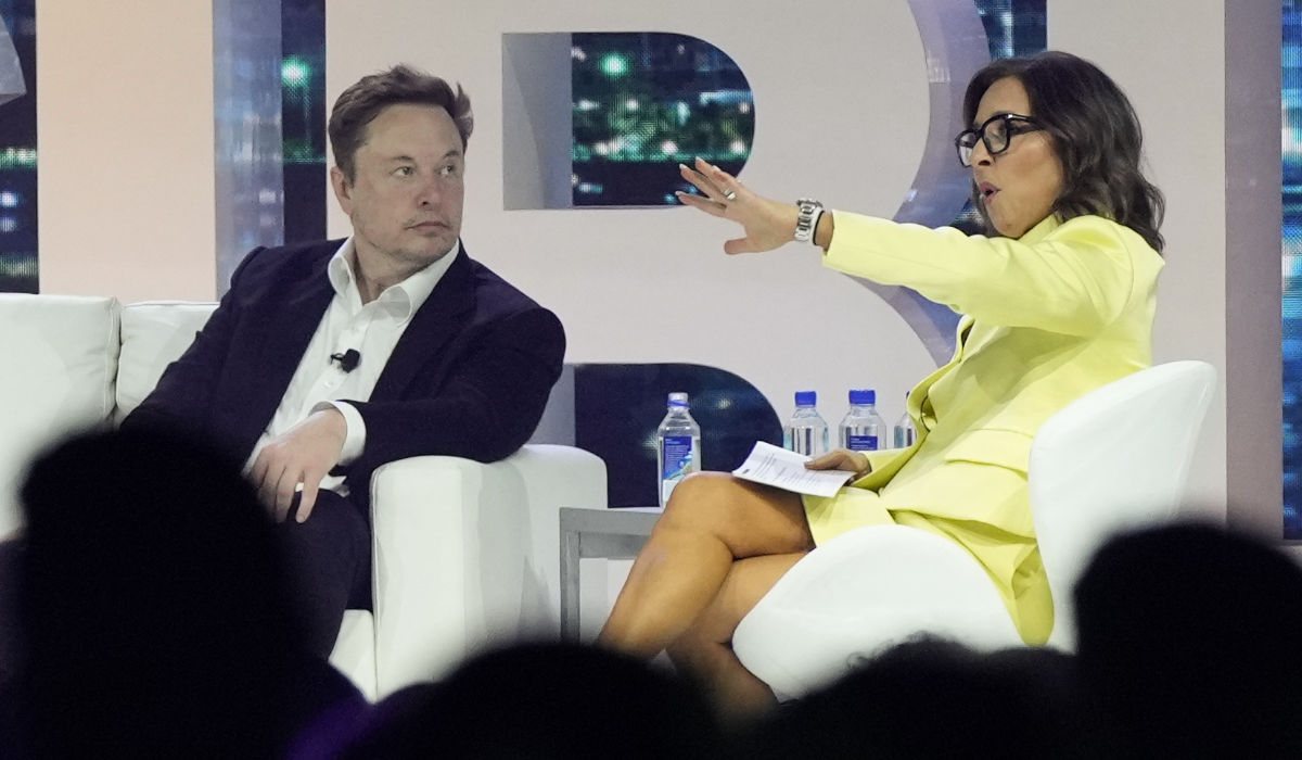 Twitter CEO Elon Musk, center, speaks with Linda Yaccarino, chairman of global advertising and partnerships for NBC, at the POSSIBLE marketing conference, Tuesday, April 18, 2023, in Miami Beach, Fla. (AP)