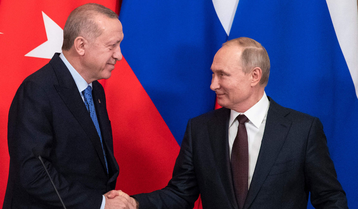 In this file photo taken on March 05, 2020 Russian President Vladimir Putin and his Turkish counterpart Recep Tayyip Erdogan shake hands at the end of a joint press statement following their talks at the Kremlin in Moscow. (AFP)