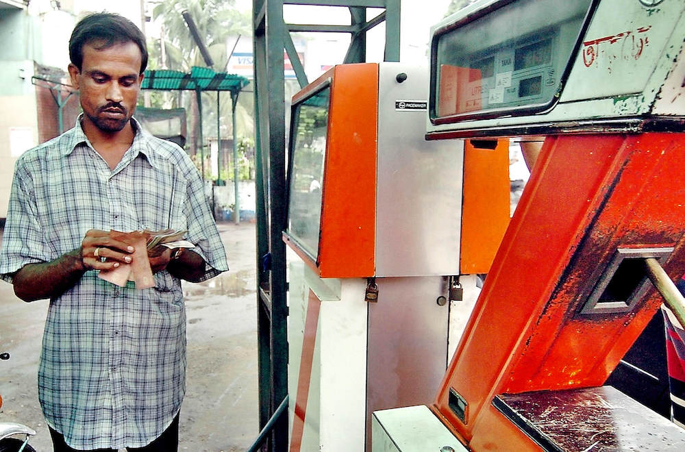 A Bangladeshi petrol station employee counts bank notes in Dhaka. (File/AFP)