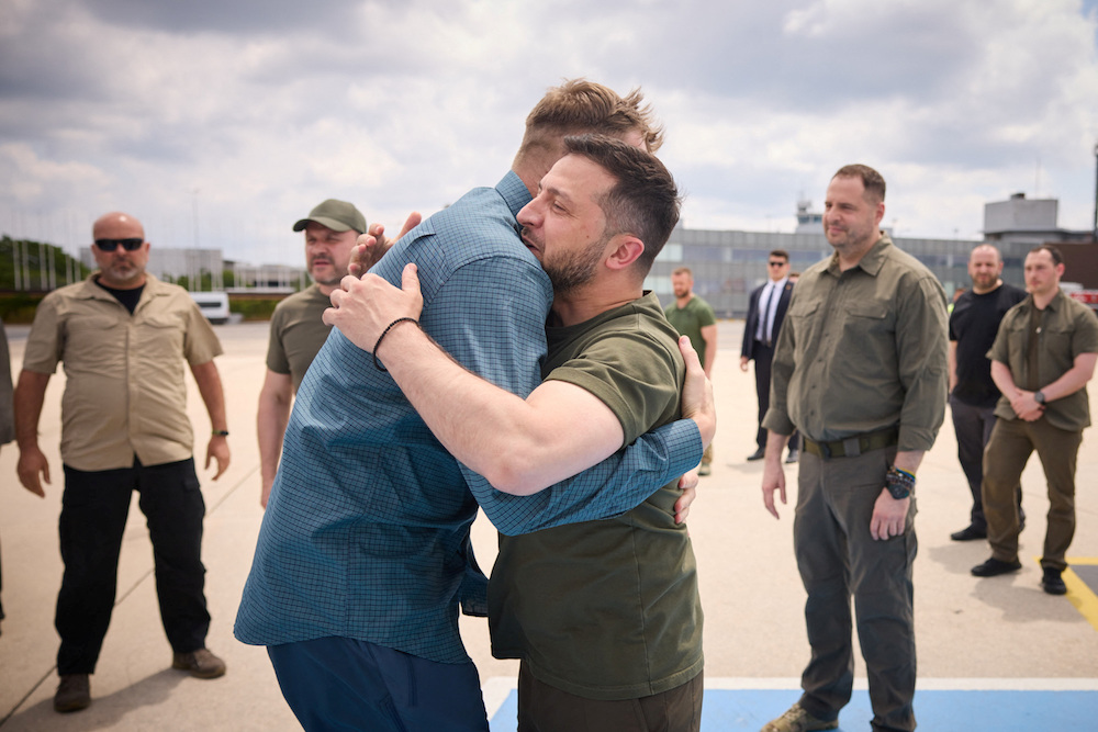 Ukraine's President Volodymyr Zelensky embraces one of commanders of defenders of the Azovstal Iron and Steel Works in Mariupol Denys Prokopenko as they return to Ukraine from Istanbul. (Ukrainian Presidential Press Service via Reuters)