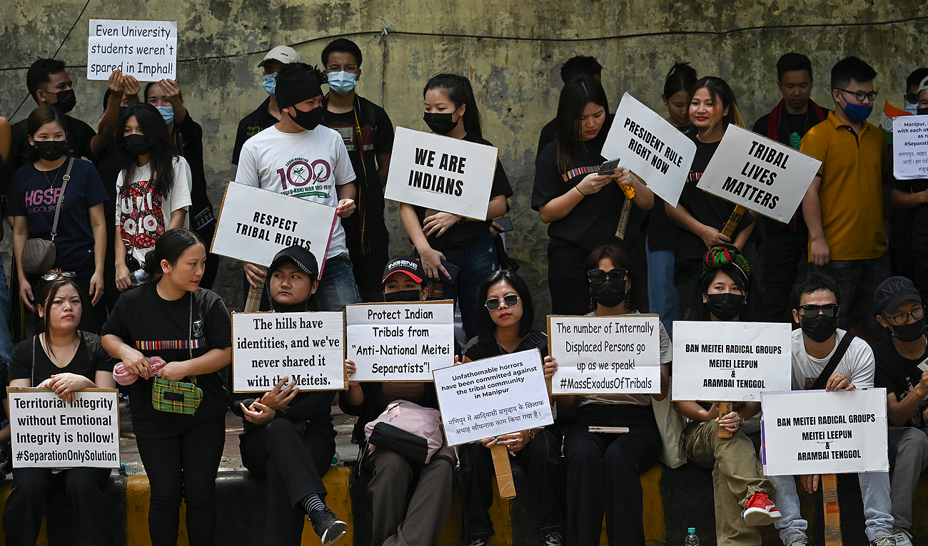 Activists of the All Tribal Students Union Manipur (ATSUM) hold placards during a protest amid ongoing ethnic violence in India's northeastern Manipur state, in New Delhi on May 31, 2023. (AFP)