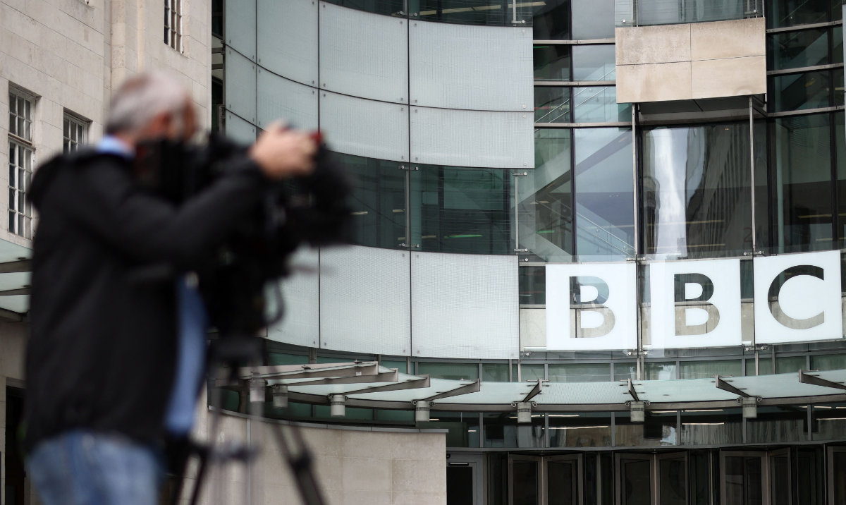 A member of the media works outside BBC Broadcasting House in central London on July 9, 2023. (AFP)