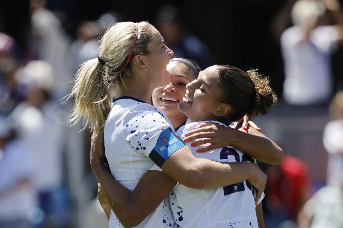 US midfielder Lindsey Horan, left, and Sophia Smith, center, celebrate with forward Trinity Rodman, right, who scored in the second half of a FIFA Women's World Cup send-off soccer match against Wales in San Jose, California on Sunday. (AP)