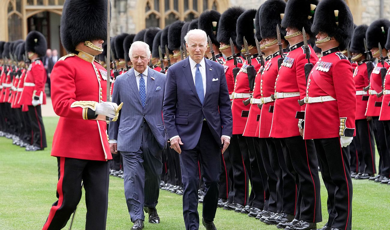 U.S. President Joe Biden and Britain's King Charles review an honour guard at Windsor Castle in Windsor, England, Monday, July 10, 2023. (REUTERS)
