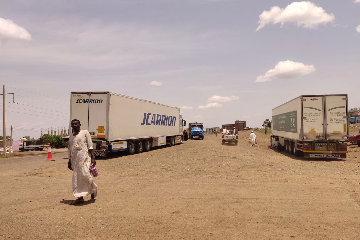 Trucks carrying foreign humanitarian aid pass by Gadaref on the main road linking Khartoum with Port Sudan on July 10, 2023. (AFP)