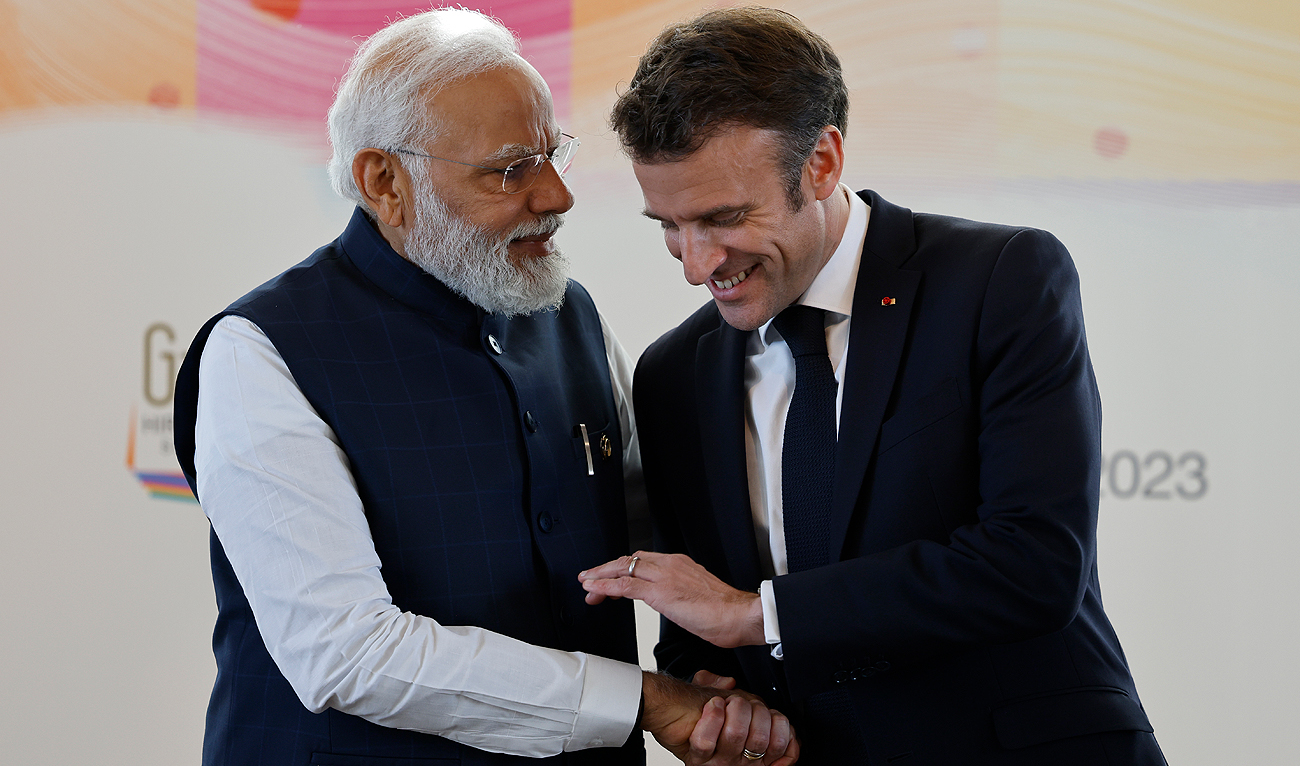 India's Prime Minister Narendra Modi (L) shakes hands with France's President Emmanuel Macron during a bilateral meeting on the sidelines of the G7 Leaders' Summit in Hiroshima on May 20, 2023. (AFP/File)