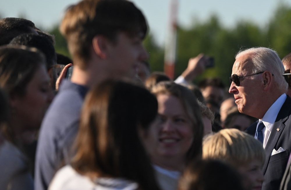 US President Joe Biden speaks with well-wishers upon his arrival at Vilnius International Airport, Lithuania, July 10, 2023. (AFP)