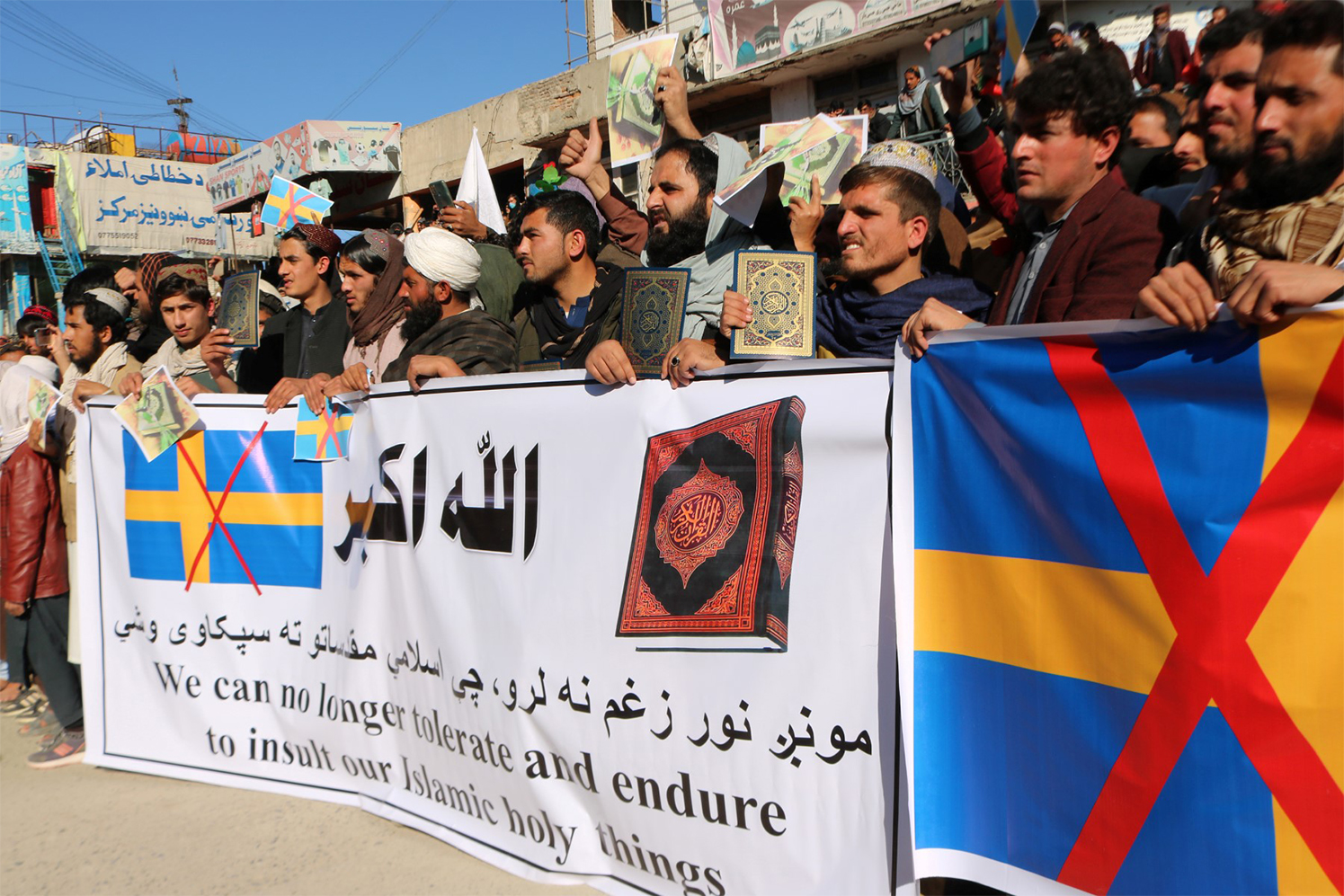Protesters hold a banner during a demonstration against the burning of the Koran by Swedish-Danish far-right politician Rasmus Paludan, in Khost, on January 24, 2023. (AFP/File)