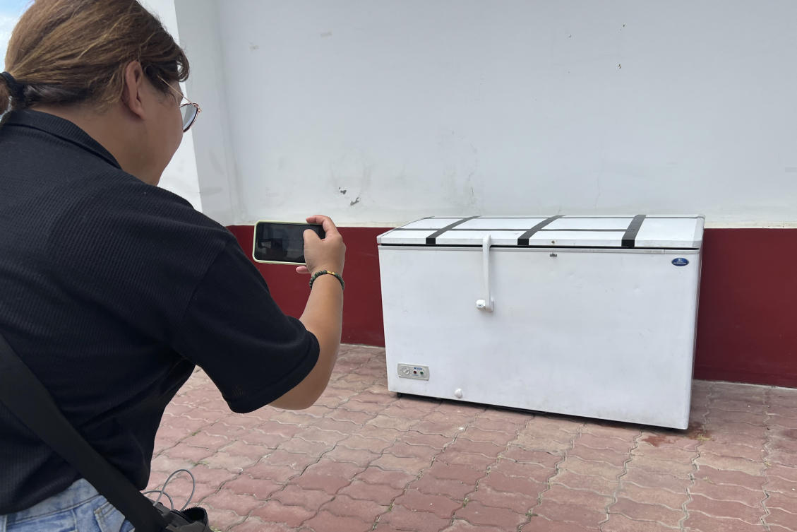 A Thai reporter takes a photo of an empty freezer at the Nong Prue police station in Pattaya, Chonburi province, Thailand, on July 11, 2023. (AP)