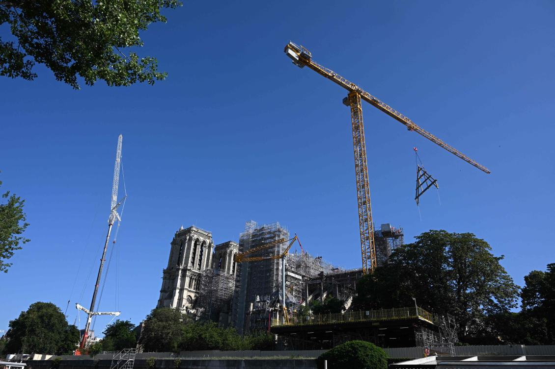 A timber truss is craned from a barge on the River Seine, to Notre-Dame de Paris Cathedral during its restoration following a massive fire 4-years-ago, in Paris on July 11, 2023. (AFP)